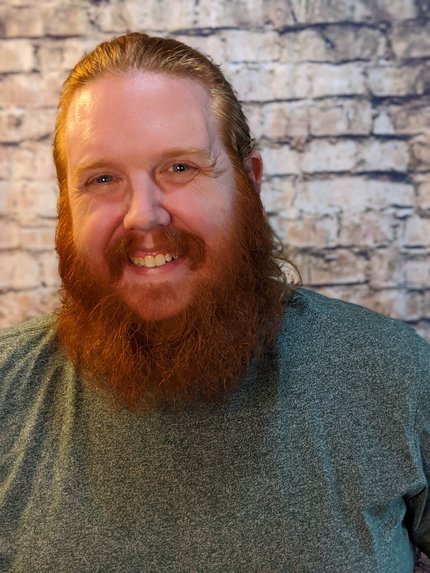 Photo of Red Stafstrom, a giant bearded man who looks like an orange sasquatch.